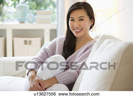 Woman relaxing on sofa View Large Photo Image Stock Photograph - Woman relaxing on sofa. Fotosearch