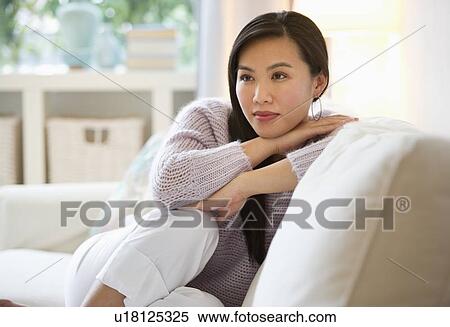 Woman relaxing on sofa View Large Photo Image Stock Photography - Woman relaxing on sofa. Fotosearch