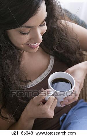 Woman relaxing with cup of coffee View Large Photo Image Stock Photo - Woman relaxing with cup of coffee. Fotosearch