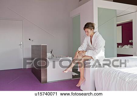 Woman shaving legs in bedroom View Large Photo Image Stock Image - Woman shaving legs in bedroom. Fotosearch