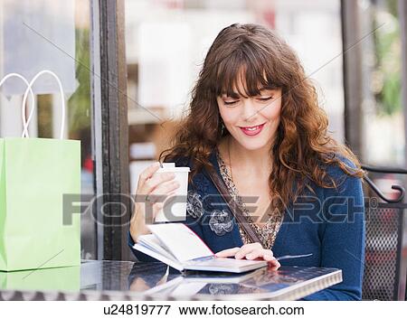 Woman sitting in sidewalk cafe View Large Photo Image Stock Photo - Woman sitting in sidewalk cafe. Fotosearch