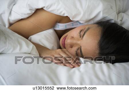 Woman sleeping in bed View Large Photo Image Stock Image - Woman sleeping in bed. Fotosearch