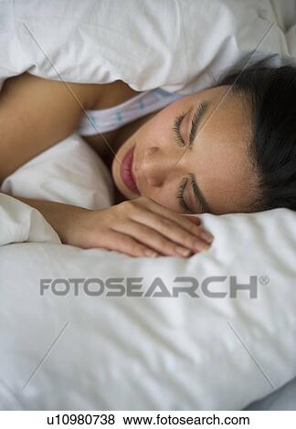 Woman sleeping in bed View Large Photo Image Stock Photo - Woman sleeping in bed. Fotosearch
