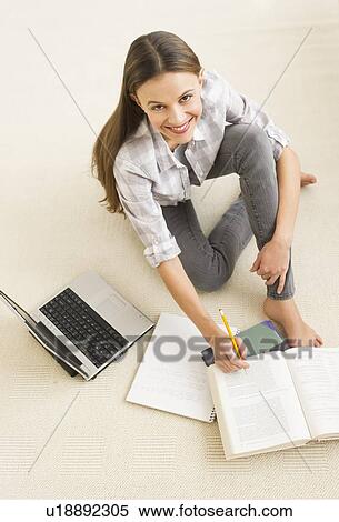 Stock Photography - Woman studying at home. Fotosearch