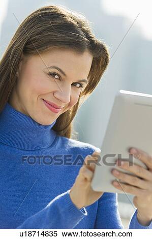 Woman using digital tablet outdoors View Large Photo Image Stock Photography - Woman using digital tablet outdoors. Fotosearch