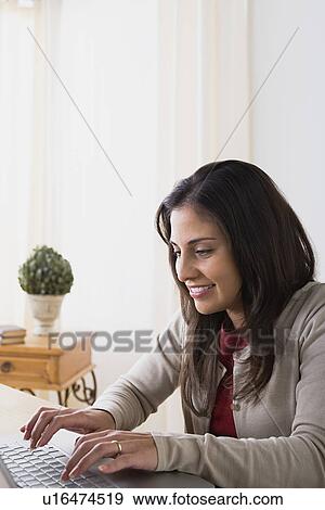 Stock Photo - Woman using laptop. Fotosearch