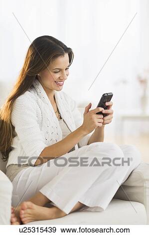 Woman using smart phone at home View Large Photo Image Stock Photo - Woman using smart phone at home. Fotosearch