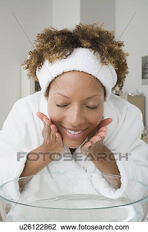 Stock Image - Woman washing face. Fotosearch