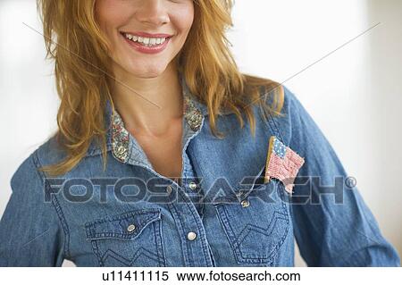 Woman wearing denim jacket with US flag in pocket, studio shot View Large Photo Image Stock Photography - Woman wearing denim jacket with US flag in pocket, studio shot. Fotosearch