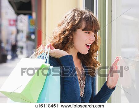 Woman window shopping View Large Photo Image Stock Image - Woman window shopping. Fotosearch