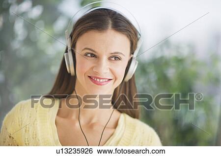 Stock Photograph - Woman with headphones outdoors. Fotosearch