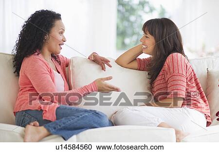 Women chatting on sofa View Large Photo Image Stock Image - Women chatting on sofa. Fotosearch