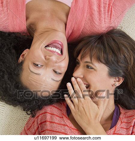 Women lying down and laughing View Large Photo Image Stock Photo - Women lying down and laughing. Fotosearch