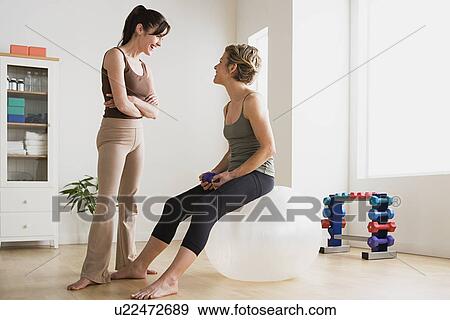 Stock Photo - Women talking in gym. Fotosearch