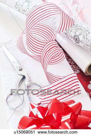 Stock Image - Wrapping paper, ribbon and scissors. Fotosearch