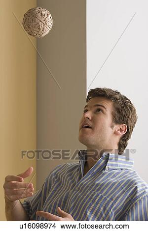 Young man playing with ball made of paper View Large Photo Image Picture - Young man playing with ball made of paper. Fotosearch