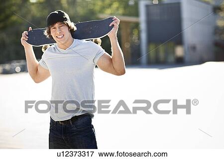 young man posing with skateboard View Large Photo Image Stock Photo - young man posing with skateboard. Fotosearch
