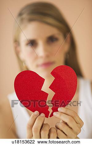 Young woman holding broken paper heart View Large Photo Image Stock Image - Young woman holding broken paper heart. Fotosearch