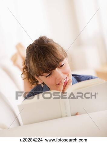 Picture - Young woman reading book. Fotosearch