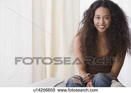 Young woman relaxing on sofa View Large Photo Image Stock Photo - Young woman relaxing on sofa. Fotosearch