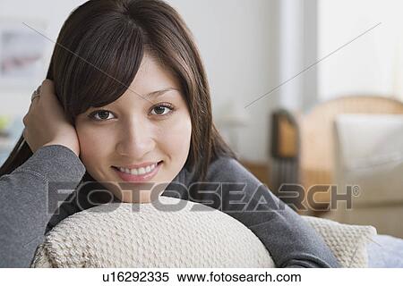 Young woman relaxing on sofa View Large Photo Image Stock Photography - Young woman relaxing on sofa. Fotosearch