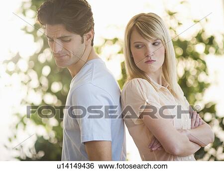Stock Photograph - Angry couple standing back to back. Fotosearch
