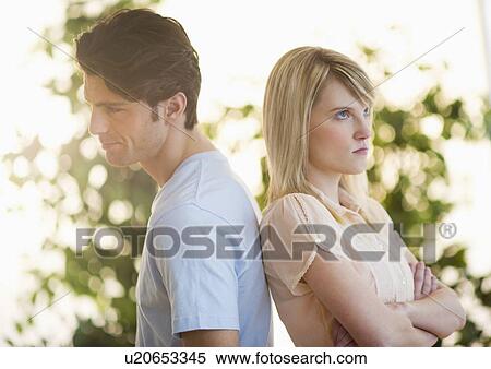 Stock Photography - Angry couple standing back to back. Fotosearch