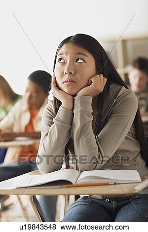 Stock Photo - Bored girl sitting in classroom. Fotosearch