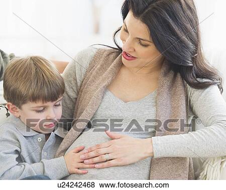 Boy (4-5) touching pregnant mother's belly View Large Photo Image Stock Photo - Boy (4-5) touching pregnant mother's belly. Fotosearch