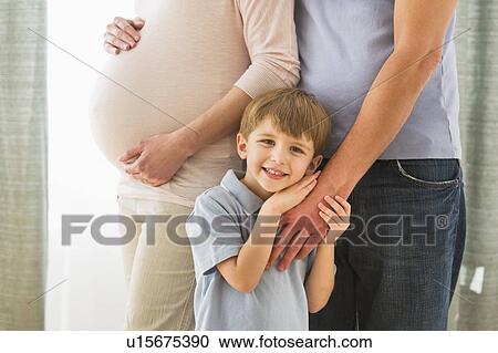 Stock Image - Boy (4-5) with parents. Fotosearch