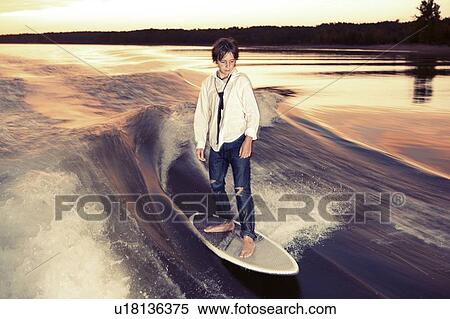 Stock Photography - Boy wakeboarding on Lake Greeson. Fotosearch