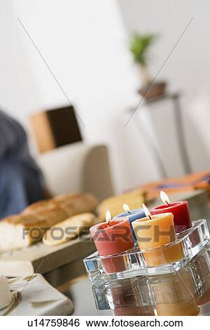 Stock Photograph - Burning candles on table. Fotosearch