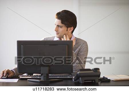 Business man working on computer View Large Photo Image Stock Image - Business man working on computer. Fotosearch
