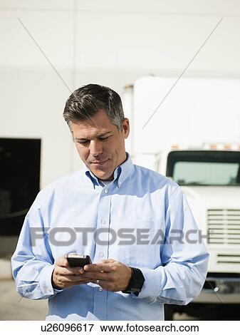 Stock Photo - Businessman texting. Fotosearch