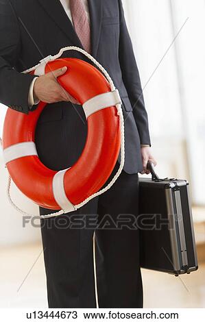 Businessman with life belt View Large Photo Image Stock Image - Businessman with life belt. Fotosearch
