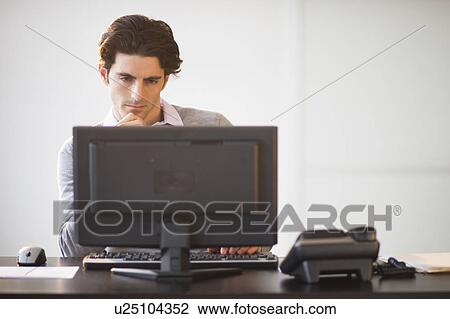 Businessman working on computer View Large Photo Image Stock Image - Businessman working on computer. Fotosearch