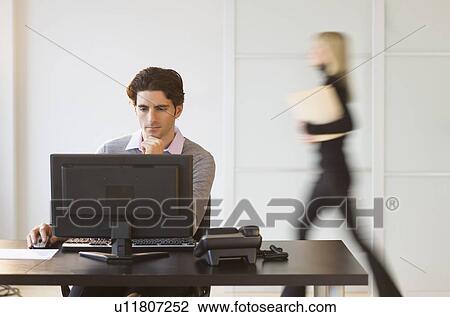 Stock Image - Businesspeople in office. Fotosearch