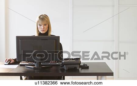 Stock Photograph - Businesswoman working on computer. Fotosearch