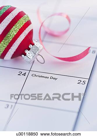 Christmas bauble on calendar View Large Photo Image Stock Image - Christmas bauble on calendar. Fotosearch