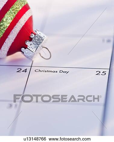 Christmas bauble on calendar View Large Photo Image Stock Photograph - Christmas bauble on calendar. Fotosearch