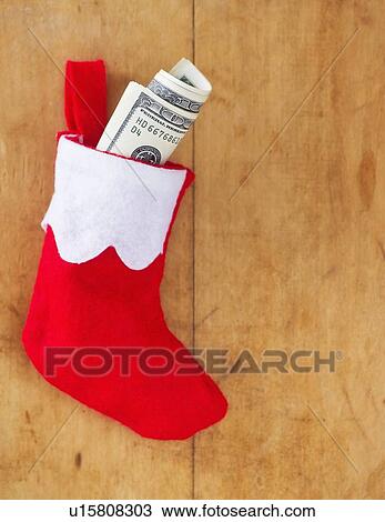 Christmas stocking with roll of banknotes View Large Photo Image Stock Image - Christmas stocking with roll of banknotes. Fotosearch