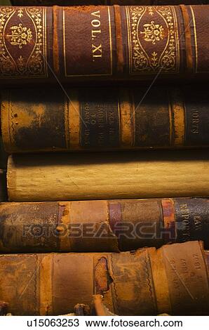 Stock Image - Close up of antique books in leather covers, studio shot. Fotosearch