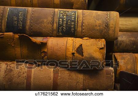 Stock Image - Close up of antique books in leather covers, studio shot. Fotosearch