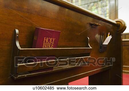 Stock Photography - Close up of bible on wooden church pew. Fotosearch