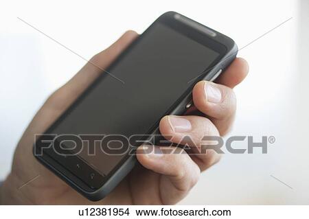 Close up of businessman's hands holding PDA View Large Photo Image Picture - Close up of businessman's hands holding PDA. Fotosearch