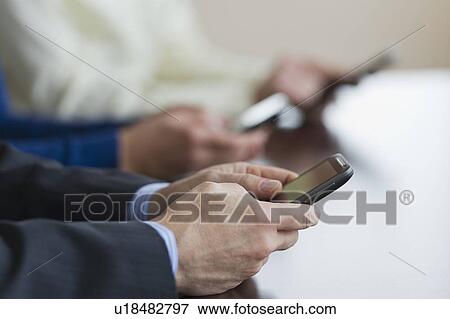 Close up of businessman's hands holding smartphone View Large Photo Image Stock Photo - Close up of businessman's hands holding smartphone. Fotosearch