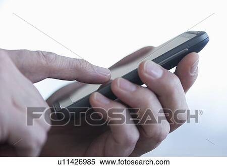 Close up of businessman's hands holding PDA View Large Photo Image Stock Photography - Close up of businessman's hands holding PDA. Fotosearch