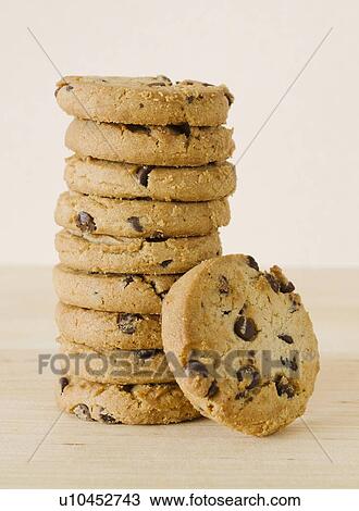 Stock Image - Close up of chocolate chip cookies, studio shot. Fotosearch
