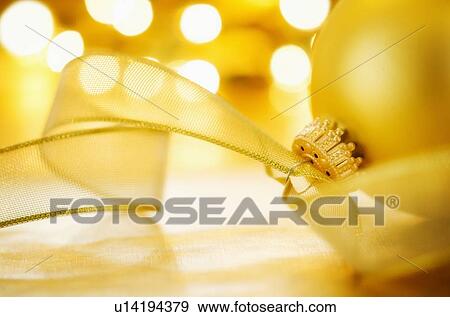 Stock Photo - Close-up of Christmas ball with ribbon, studio shot. Fotosearch