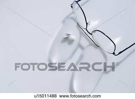 Close up of glasses and pills on white background, studio shot View Large Photo Image Stock Photo - Close up of glasses and pills on white background, studio shot. Fotosearch